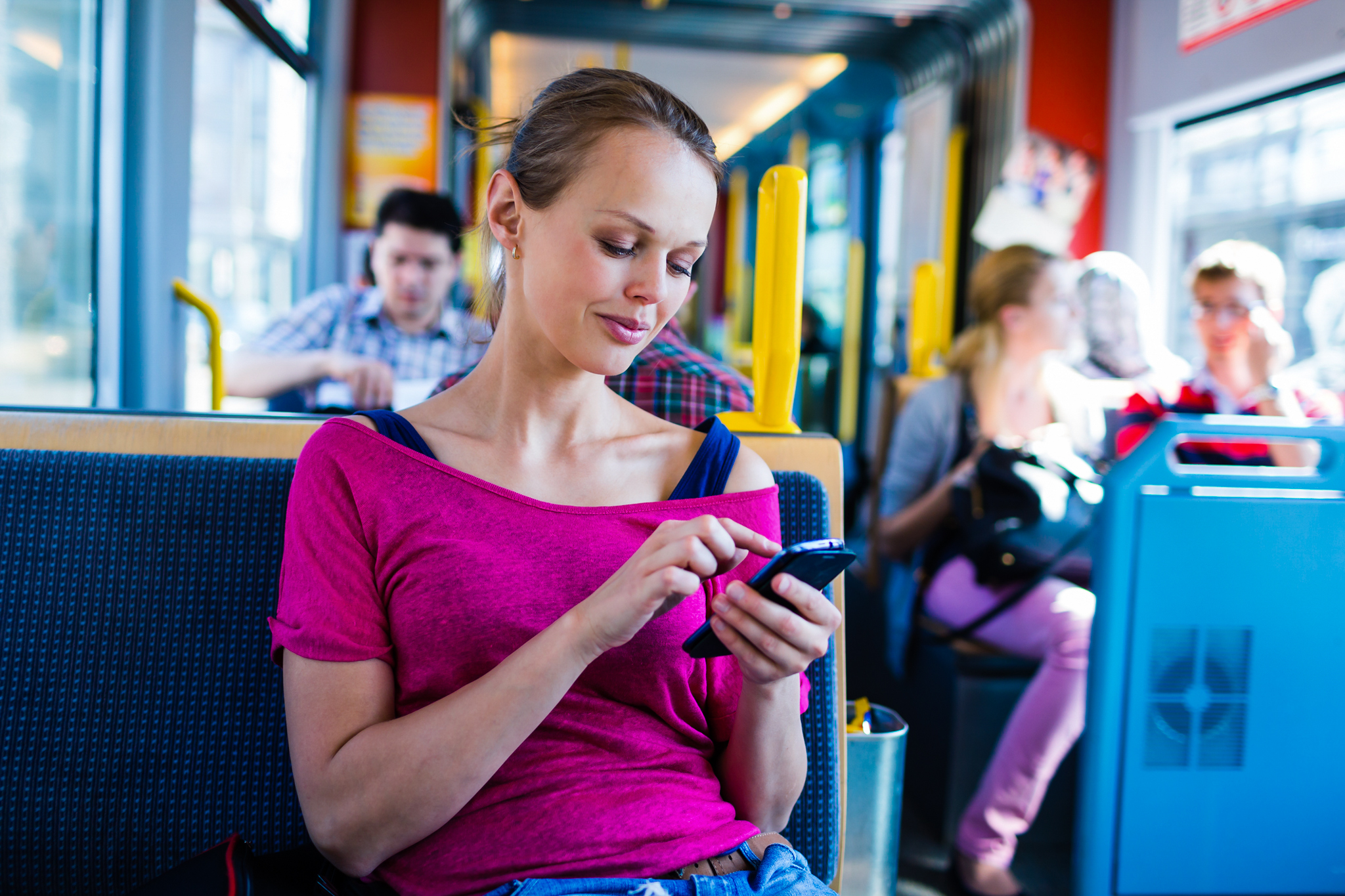 Young woman using a smartphone on a tram
