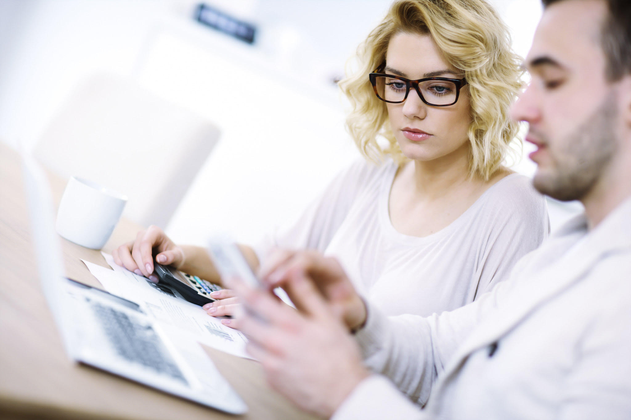 A picture of a worried couple with documents at home